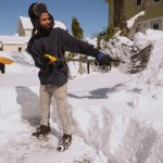 JESUS TORRES shovels out his Cranston driveway after a winter storm dumped about 3 feet of snow across Rhode Island from Feb. 22-23. Rhode Island’s congressional delegation is demanding answers as to why the Trump administration blocked disaster relief funding for the state. / AP FILE PHOTO/CHARLES KRUPA