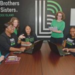 Mechanical matching: Artificial intelligence has vastly increased organizational efficiency through automating administrative and repetitive tasks at Big Brothers Big Sisters of Rhode Island.  Kaleigh Perkins, third from left, chief operating officer, and Katje Afonseca, third from right, CEO, participate in a staff meeting.  PBN PHOTO /ELIZABETH GRAHAM