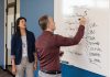 Connective Infrastructure: Michelle Wu, of WU Consulting, meets with Glenn Robertelli, RI Bio’s executive director, whose nonprofit links Rhode Island’s life sciences ecosystem.  PBN PHOTO/ TRACY JENKINS