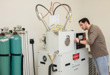 Breath analysis: Trace Sensing Technologies’ flagship platform, TRACE-E, uses patented thermodynamic sensor technology to detect molecular biomarkers in exhaled breath, improving disease detection. Peter Ricci III, founder and CEO, works on the machine.  PBN PHOTO/TRACY JENKINS