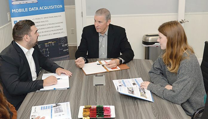 COLLABORATIVE CONFERENCE: Joseph Devine, center, president of Axiotrop LLC, meets with Dewetron Inc. Head of Operations Albon Redzepi, left, and marketing specialist Gabriella Scott at Axiotrop’s Narragansett office.
PBN PHOTO/ELIZABETH GRAHAM COLLABORATIVE CONFERENCE: Joseph Devine, center, president of Axiotrop LLC, meets with Dewetron Inc. Head of Operations Albon Redzepi, left, and marketing specialist Gabriella Scott at Axiotrop’s Narragansett office.
PBN PHOTO/ELIZABETH GRAHAM