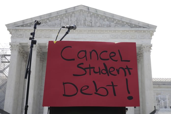 studen A DEMONSTRATION SIGN is seen outside the U.S. Supreme Court in Washington, D.C., in June 2023 before a divided high court stuck down the Biden administration's $400 billion student loan forgiveness plan. Rhode Island has the 16th-highest student loan debt burden in the nation, according to WalletHub. / AP FILE PHOTO/MARIAM ZUNHAIB