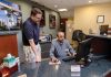 Starting Over: Christopher P. Devine, left, assistant vice president and branch manager at The Washington Trust Co., meets with bank teller Ashutosh Talukder, who took Community College of Rhode Island’s banking course after coming to the United States in 2025. PBN PHOTO/TRACY JENKINS