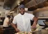 CHEERFUL CHEF: ­Cedrick Almonacy, sous chef at Celeste restaurant in Narragansett, puts the finishing touches on a pizza. Almonacy said he has enjoyed cooking since childhood. PBN PHOTO/ELIZABETH GRAHAM