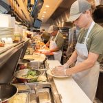 Recipe for success: Tyler Gill, foreground, splits his time between working at the J.T. Commons restaurant in Middletown with his classes at the Community College of Rhode Island.  PBN PHOTO/STEPHANIE BERNABA