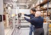 looking to the Future: Nate Fischer, left, director of product management at Taco Comfort Solutions, and John Forcino, vice president of operations, are helping mentor and grow the next generation of manufacturing leaders. PBN PHOTO/TRACY JENKINS