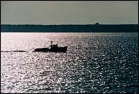 Lone fishing boat navigatesNarragansett Bay. Lone fishing boat navigates<br>Narragansett Bay.