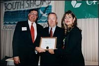 Joe Rizzo (center), president of TigerHome Inspection, accepts his award. Joe Rizzo (center), president of Tiger<br>Home Inspection, accepts his award.