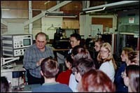 Explaining the work at PerkinElmer tostudents is Phil D'Ercole, facilitiesmanager. Explaining the work at PerkinElmer to<br>students is Phil D'Ercole, facilities<br>manager.