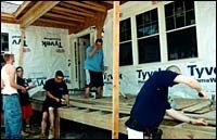 Students from Woonsocket Career andTechnical Center work on an energylean home. (Al Alexio) Students from Woonsocket Career and<br>Technical Center work on an energy<br>lean home. (Al Alexio)