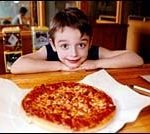 Niko Cappola eyes a pizzaat Minerva Pizza House.(Brian McDonald)
