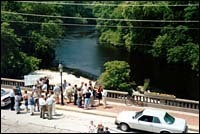 R.I. Rivers Council members gatherfor budget announcements on aPawtuxet River bridge. R.I. Rivers Council members gather<br>for budget announcements on a<br>Pawtuxet River bridge.