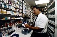 Pharmacist at work is RichardBacker at East Side PrescriptionCenter. (Tom Croke) Pharmacist at work is Richard<br>Backer at East Side Prescription<br>Center. (Tom Croke)