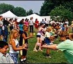 Companies weigh costs, benefits of outings Bank RI employees and theirfamilies toss water balloons atTwelve Acres in Smithfield.