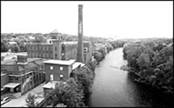 MILL BUILDINGS still line the Blackstone River but the production of textiles has dwindled. MILL BUILDINGS still line the Blackstone River<br> but the production of textiles has dwindled.