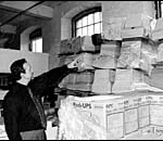Piles of computer terminals are pointed to by Rick Gosselin.