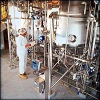 Immunex worker monitors a purifi-cation professor. Immunex worker monitors a purifi-<br>cation professor.