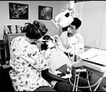 Bill seeks direct payment for non-network dentists Dentists team up to work on a patient at the Joseph Samuels DentalCenter in Providence.