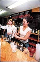 Chloe Villano practicesher mixing skills atthe Rhode Island School of Bartending.