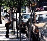 A Providence meter maid writes aticket for a parking violation.