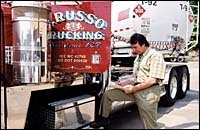 Checking his manifest is David Russo of Russo Trucking. Checking his manifest is David Russo <br>of Russo Trucking.