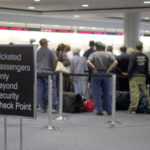 Waiting for clearance, airline passengers at Logan Airportgather at checkpoint.