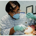 Checking a patient's mouth is Christopher Walinski.