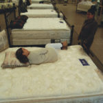 Furniture sales evading slump Catching a quick nap, a customertries a mattress at Off Track Bedding.