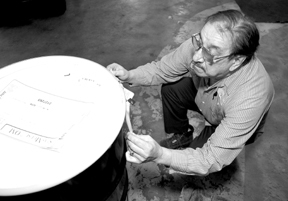 Hess employee Bernie DeLielle labels a drum filledwith chemicals to be delivered to a customer. Hess employee Bernie DeLielle labels a drum filled<br>with chemicals to be delivered to a customer.