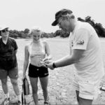 Ecotour co-owner Mark Baker shows clients a frog he pulleda lake in the Amazons.