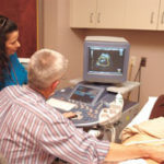 Here’s looking at you kid Dr. Stephen Carr administers an ultrasound to expectantmother Carolyn Slack.