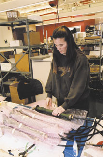 A KVH Industries worker prepares productfor shipment. A KVH Industries worker prepares product<br>for shipment.