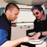 Private flying licenses taking off Alfred J. Mello Jr., right, reviews flightplans with flight instructor Scott McCoy.