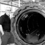Eric Hall, president of Hall Spars & Rigging, displayshis company's autoclave.