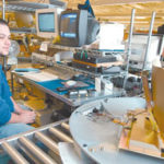 A KVH production worker mans a workstation at thecompany's Middletown plant.