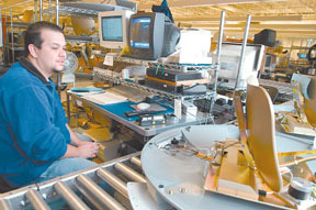 A KVH production worker mans a workstation at thecompany's Middletown plant. A KVH production worker mans a workstation at the<br>company's Middletown plant.