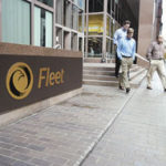 Individuals leave Fleet Rhode Island headquartersin Providence.