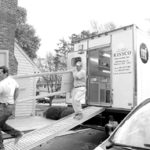 Bob O'Donnell and Peter Pacheco move a countertopoff their MobileFab truck.