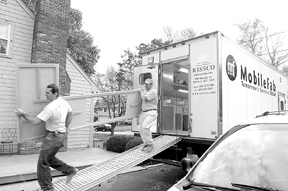 Bob O'Donnell and Peter Pacheco move a countertopoff their MobileFab truck. Bob O'Donnell and Peter Pacheco move a countertop<br>off their MobileFab truck.