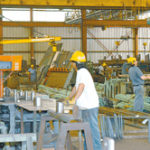 Workers at the Barker Steel Company's Pawtucket facility manufacture rebar and prepare it for shipping. 
