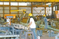 Workers at the Barker Steel Company's Pawtucket facility manufacture rebar and prepare it for shipping. Workers at the Barker Steel Company's Pawtucket facility manufacture rebar and prepare it for shipping.
