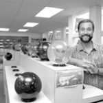 Bowling business is regional kingpin The Bowler's Edge in Pawtucket boasts more than 100 different models of bowling balls. Store owner Wayne Lima poses with just a few of his more unique products.