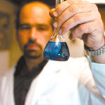 Dave Mainelli, a sales and service engineer with Bardon's Water Services, inspects water treatment chemicals. 