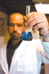 Dave Mainelli, a sales and service engineer with Bardon's Water Services, inspects water treatment chemicals. Dave Mainelli, a sales and service engineer with Bardon's Water Services, inspects water treatment chemicals.