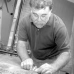 Steve Staples, shown planing wood in his workshop, has helped his company persevere by offering a range of services over the years. 