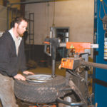 Used tire business still rolling along John Butler, of Butler Tire in North Attleboro, works with a tire and wheel at the 36-year old family business.