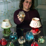 Photo by Brian McDonaldChristine Barrette of Gel Lights candle shop in Woonsocket trades some of her inventory with a local exchange company.