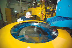 <b>Photo by Brian McDonald</b>Peggy Droulet, an employee at Polytop Corp., a Slatersville manufacturer, feeds safety caps into an automation system. The company is expanding but is having trouble finding skilled workers. <b>Photo by Brian McDonald</b><br>Peggy Droulet, an employee at Polytop Corp., a Slatersville manufacturer, feeds safety caps into an automation system. The company is expanding but is having trouble finding skilled workers.