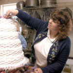 Icing on the cake: Karen Smith, owner of Perry's Bakery in Westport, Mass., puts the finishing touches on a six-layer cake. 