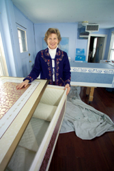<b>Photo by Brian McDonald</b>Denise Baxter displays one of her custom-designed and painted coffins at Blue Light Coffin Co. The wooden boxes, lined with upholstery, are sometimes mistaken for hope chests. The colorful coffins go for about $1,800. <b>Photo by Brian McDonald</b><br>Denise Baxter displays one of her custom-designed and painted coffins at Blue Light Coffin Co. The wooden boxes, lined with upholstery, are sometimes mistaken for hope chests. The colorful coffins go for about $1,800.